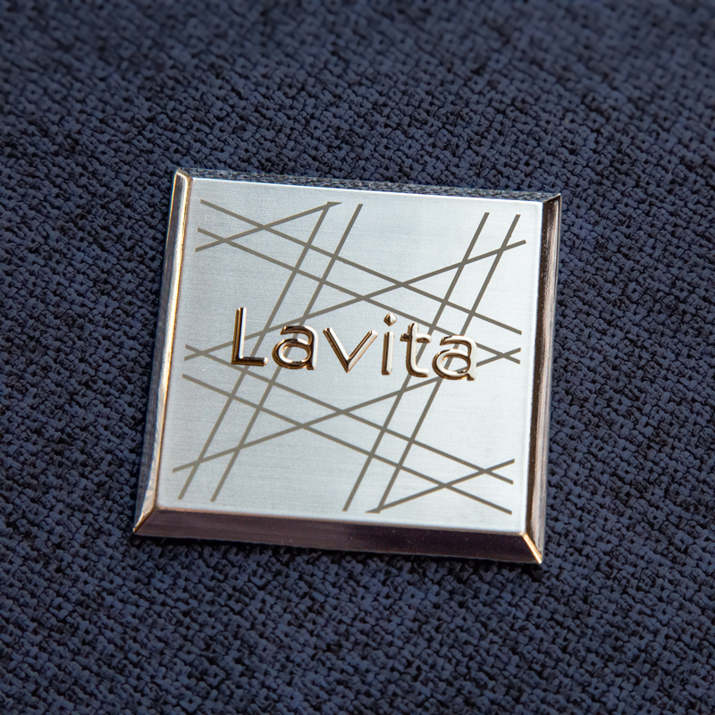 Injection-molded plastic sign with metallization, edges in shiny silver and brushed silver surface using hot stamping. Lines printed using screen printing + genuine metal Transcript A.T. lettering in shiny silver.