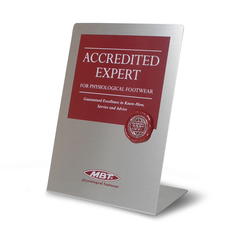 Angled aluminum (horizontally brushed). Two-color screen printing and three-dimensional red plastic injection-molded seal with silver hot stamping.